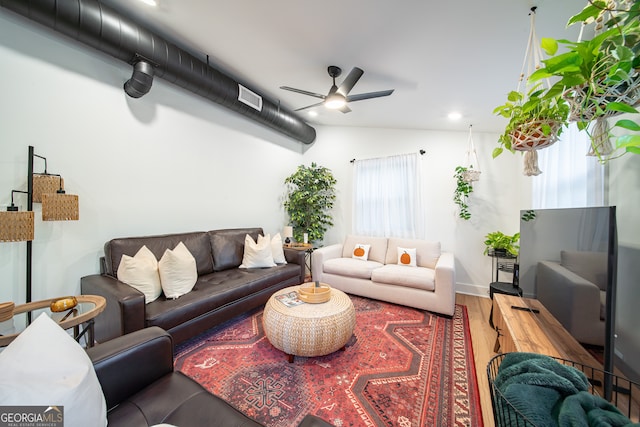 living room featuring vaulted ceiling, hardwood / wood-style flooring, and ceiling fan