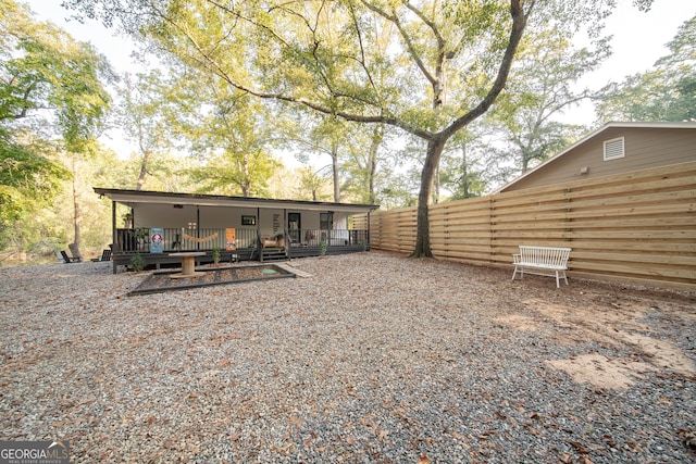 rear view of house with a wooden deck