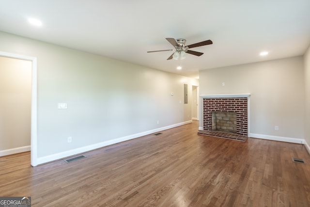 unfurnished living room featuring a fireplace, wood-type flooring, and ceiling fan