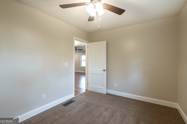 empty room featuring ceiling fan and carpet flooring