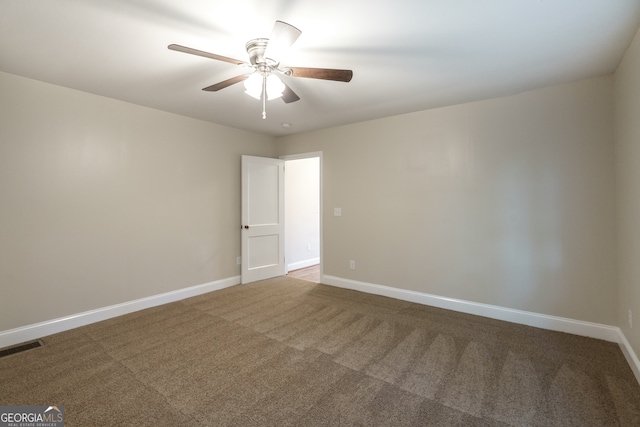 empty room with carpet flooring and ceiling fan