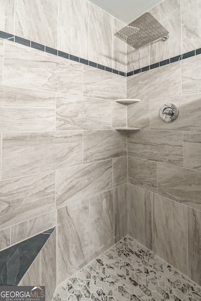 bathroom with tiled shower