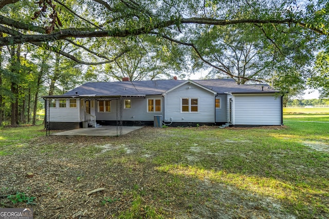 rear view of property with a patio and a lawn