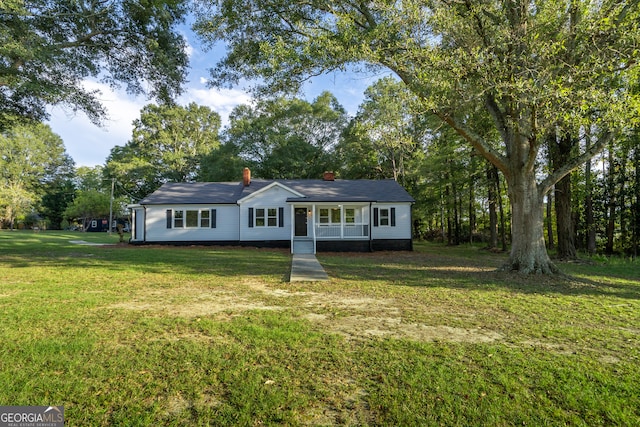 ranch-style home featuring a front yard