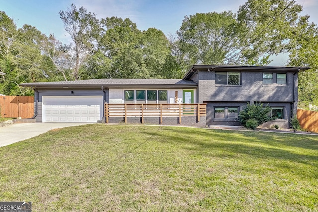 tri-level home with a front yard and a garage