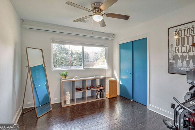 misc room featuring dark hardwood / wood-style floors and ceiling fan