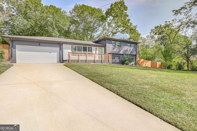 tri-level home featuring a front yard and a garage