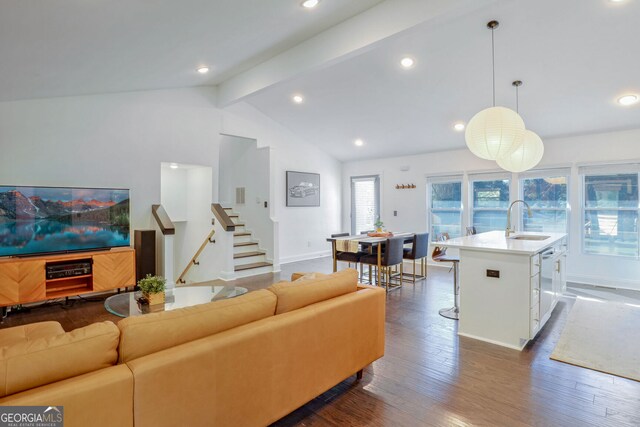 living room featuring sink, lofted ceiling with beams, and dark hardwood / wood-style floors