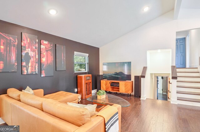 living room featuring high vaulted ceiling and wood-type flooring