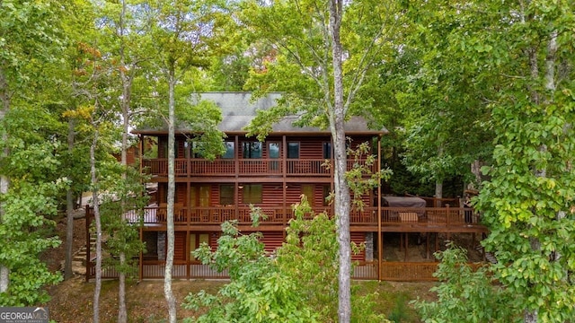 rear view of house featuring a wooden deck