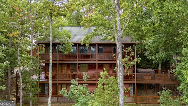 back of property featuring a wooden deck