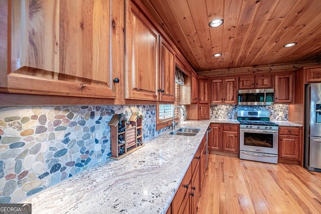 kitchen featuring sink, light hardwood / wood-style flooring, light stone countertops, appliances with stainless steel finishes, and wood ceiling