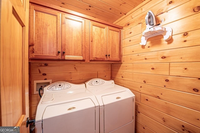 laundry area with cabinets, separate washer and dryer, wooden walls, and wooden ceiling