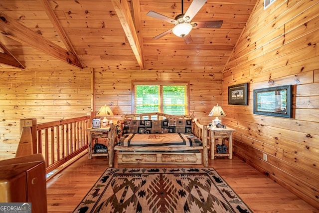 interior space featuring lofted ceiling with beams, light hardwood / wood-style floors, wooden ceiling, and wood walls