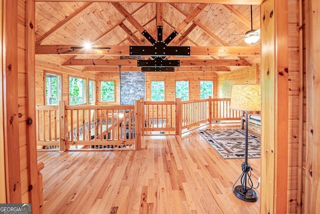 interior space featuring beamed ceiling, hardwood / wood-style flooring, wood walls, and wood ceiling