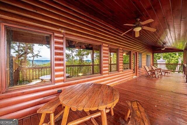 wooden deck featuring a porch and ceiling fan