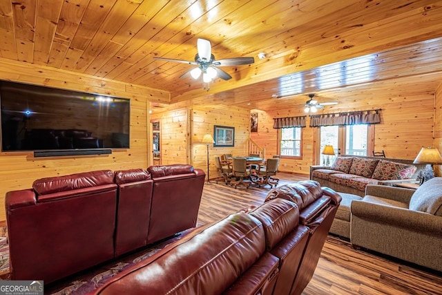 living room with wood walls, ceiling fan, wood ceiling, and hardwood / wood-style flooring