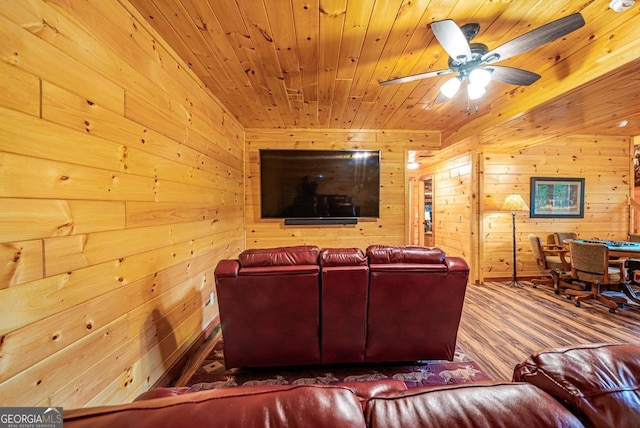 living room featuring wood walls, hardwood / wood-style floors, ceiling fan, and wood ceiling