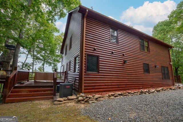 view of property exterior featuring central AC and a wooden deck