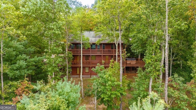 rear view of property featuring a wooden deck