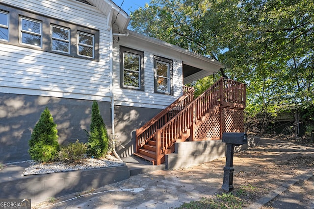 view of exterior entry featuring a wooden deck