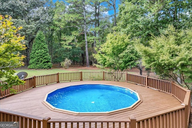 view of swimming pool featuring a deck