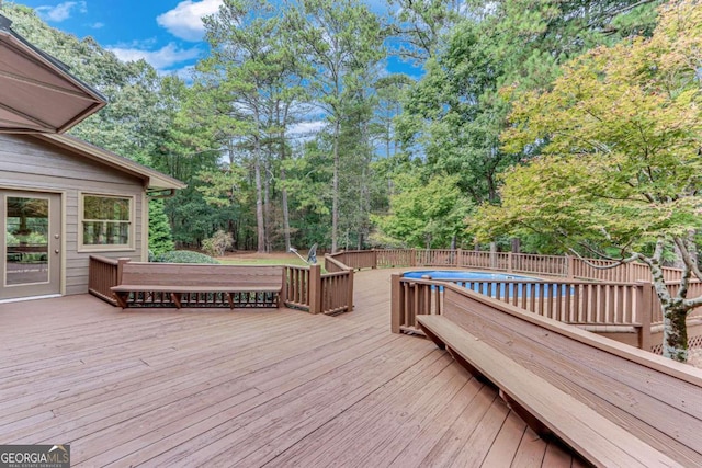 wooden deck featuring a fenced in pool