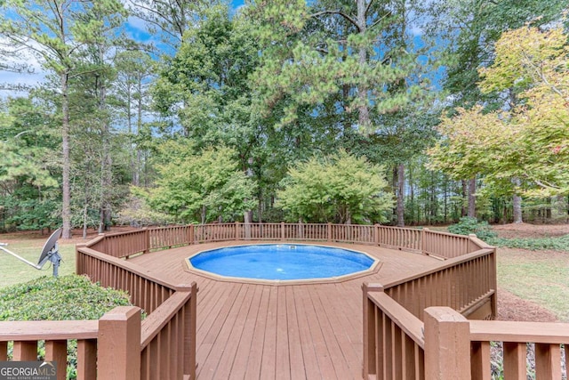 view of pool featuring a jacuzzi and a deck