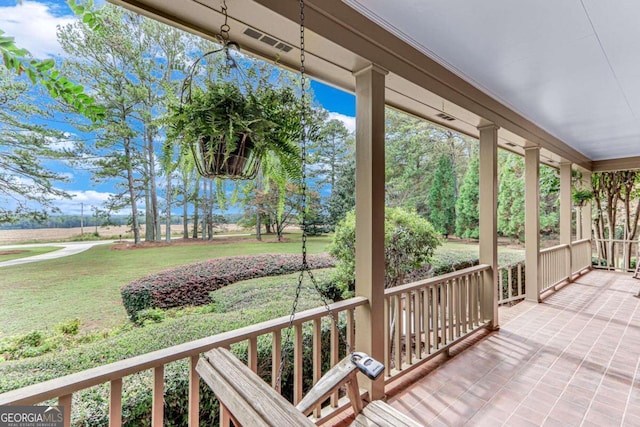 exterior space featuring a porch and a yard