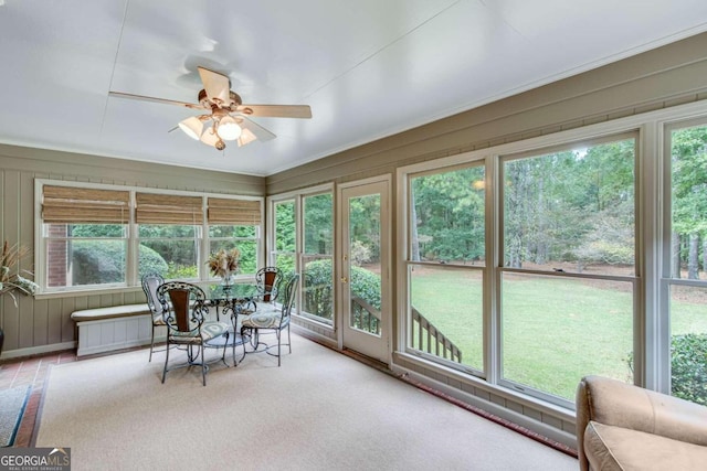 sunroom featuring ceiling fan