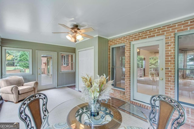 sunroom featuring ceiling fan