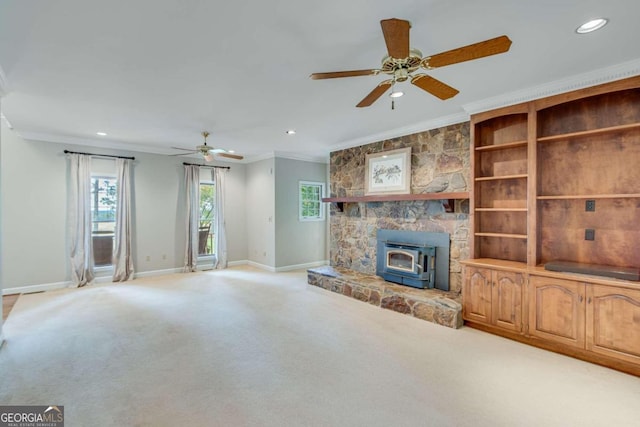 unfurnished living room with light carpet, crown molding, and a wood stove