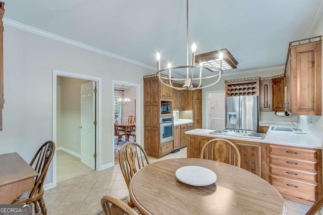 tiled dining room featuring sink, a chandelier, and ornamental molding