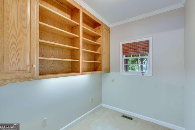 carpeted spare room featuring crown molding