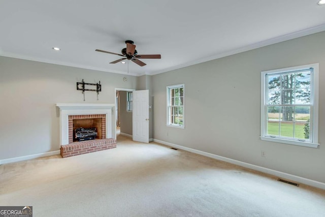 unfurnished living room featuring light carpet, ornamental molding, and a healthy amount of sunlight