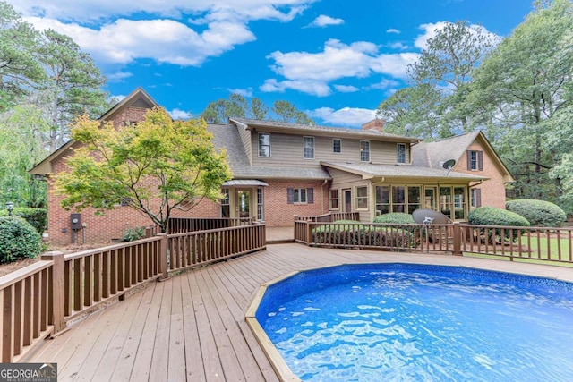 view of swimming pool with a deck