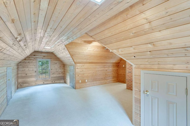 bonus room with light carpet, wood walls, lofted ceiling with skylight, and wooden ceiling