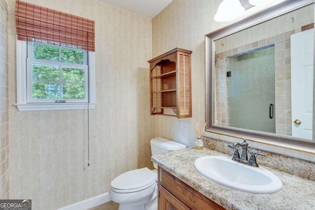 bathroom featuring walk in shower, vanity, and toilet