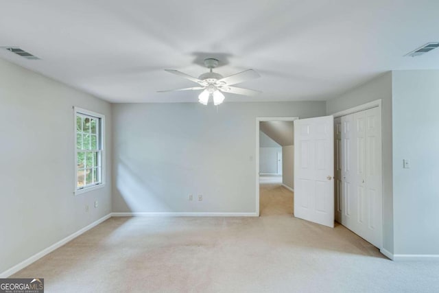 carpeted empty room with ceiling fan