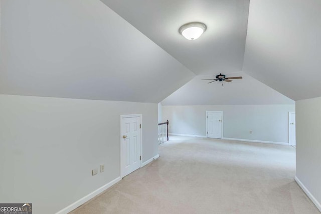 bonus room featuring ceiling fan, light colored carpet, and vaulted ceiling