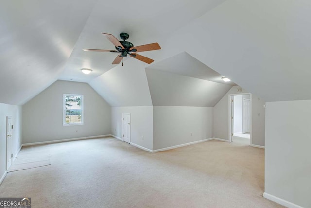 additional living space with light carpet, lofted ceiling, and ceiling fan