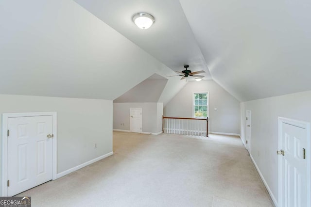 bonus room featuring light colored carpet, vaulted ceiling, and ceiling fan