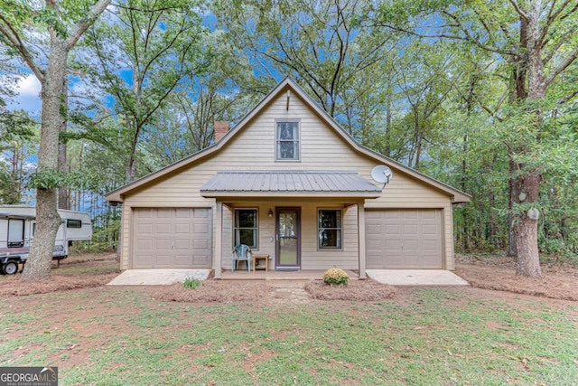 view of front of property featuring covered porch and a garage