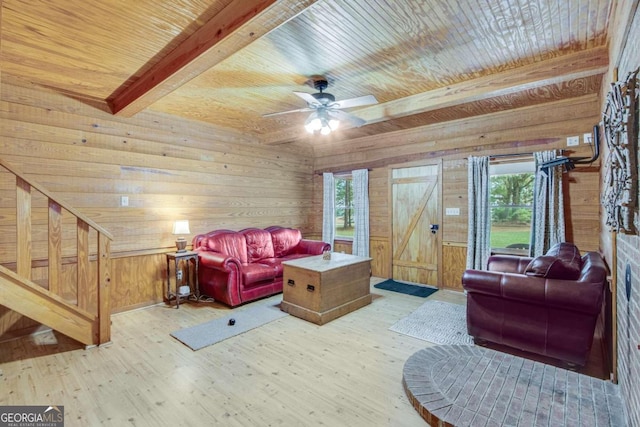 living room featuring wood walls, wooden ceiling, light wood-type flooring, and a wealth of natural light