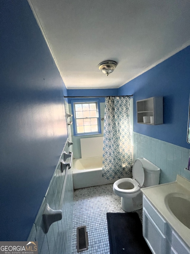 full bathroom with tile walls, vanity, tile patterned flooring, toilet, and shower / bath combo with shower curtain