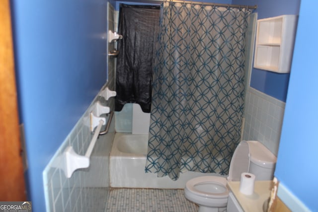 full bathroom featuring toilet, tile walls, tile patterned flooring, vanity, and shower / tub combo with curtain