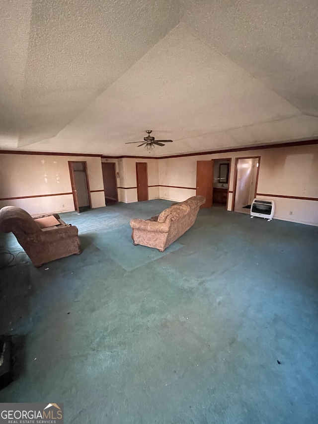 unfurnished living room with lofted ceiling, a textured ceiling, ceiling fan, and heating unit