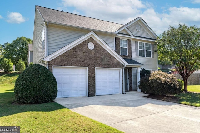 view of property with a garage and a front lawn