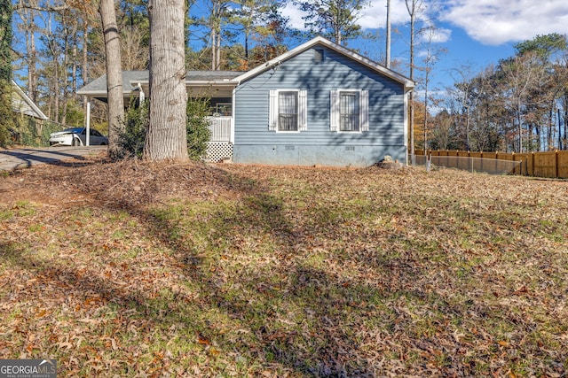 view of side of home with covered porch