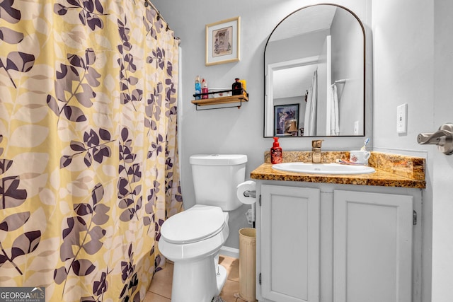 bathroom with tile patterned flooring, vanity, and toilet